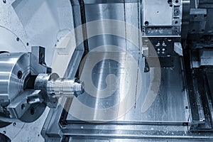 The CNC lathe machine forming cutting the metal shaft parts