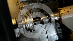 CNC lathe pulls out part of metal workpiece pulley, modern lathe for metal processing, close-up, tool