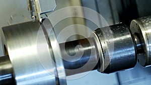 CNC lathe pulls out part of metal workpiece pulley, modern lathe for metal processing, close-up, tooling