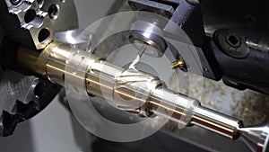 The CNC lathe or turning machine milling slot on the brass shaft with the flat end-mill tool.