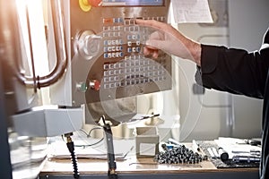 Cnc machine controls, male hand.