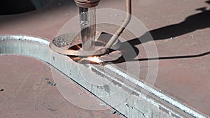CNC machine cuts through metal on given trajectory closeup