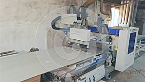 CNC machine for cutting chipboard in operation, working CNC machine. CNC cutting chipboard
