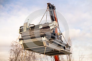 Cnc machine hanging on hook crane.