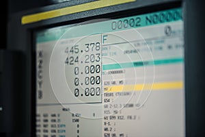 CNC machine monitor display with program code running and numbers