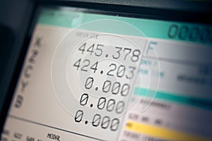 CNC machine monitor display with program code running and numbers