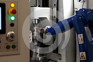 CNC machine and robotic arm loading workpieces