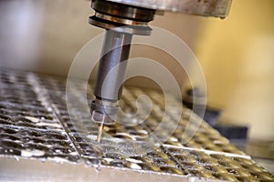 The CNC milling machine cutting the automotive mold part