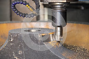 The CNC milling machine cutting the cast iron by indexable tool.