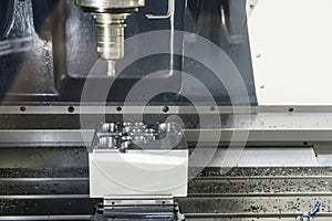 The CNC milling machine cutting cutting the raw