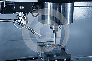 The CNC milling machine cutting the injection mold part .