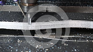 The CNC milling machine cutting press die part by solid bull end mill tool and G-code data background