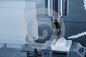 The CNC milling machine finishing cut the plastic parts with the solid ball  endmill tools. photo