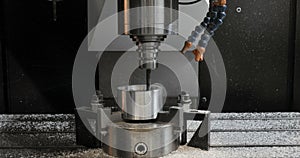 CNC milling machine produces metal detail on factory.