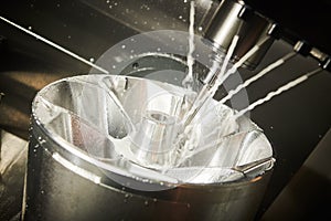 CNC milling machine work. Coolant and lubrication in metalwork industry