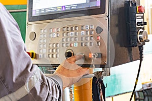 The cnc operator writes a program to control the metal processing machine. Management of the machining center