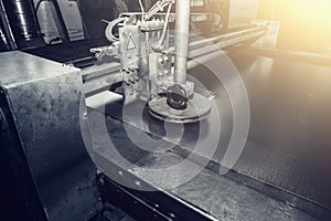 CNC programmable laser plasma cutting machine cuts sheet of metal