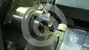 Cnc silver bar cutting lathe. silver ring production. industrial precision cutting in cnc machine in the workshop. wedding ring pr