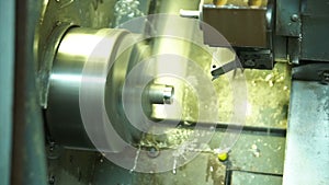 Cnc silver bar cutting lathe. silver ring production. industrial precision cutting in cnc machine in the workshop. wedding ring pr