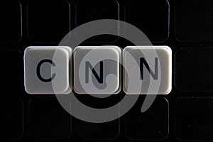Cnn control text word title caption label cover backdrop background. Alphabet letter toy blocks on black reflective background. photo
