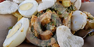 CNN winning top food called gado gado, or lotek, consists of various vegetables, eggs, tempeh, and lontong with peanut sauce photo