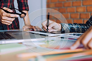 Co-worker working with graphic design in office room together. photo