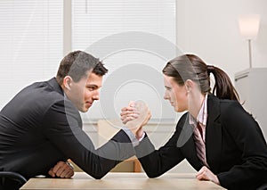 Co-workers arm wrestling for dominance