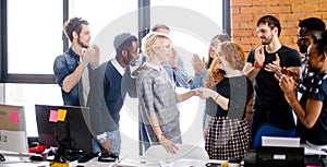 Co-workers are congratulating new employee who has done work experience