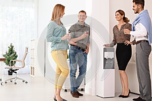 Co-workers having break near water cooler