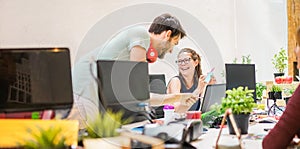 Co-workers planning a at startup in creative office - Happy teamwork preparing new business strategy - Focus on glasses woman -