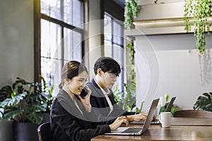 Co-working space concept. Young staff are consulting with beautiful female employees. Company employees are sitting in front of