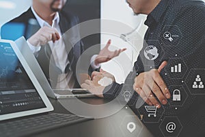 Co working team meeting concept,Man using VOIP headset with digital tablet and latop computer and smart phone in modern office