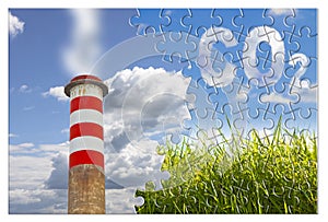 CO2 concept image in jigsaw puzzle shape against a green wild grass on sky background and an high concrete chimney emits fumes