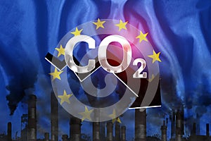 CO2 emissions into the atmosphere. Pipes with black smoke against the background of the EU flag. Industrial air pollution concept