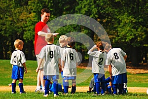 A coach assigns positions at a youth soccer game