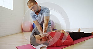 Coach assisting a woman in fitness studio 4k