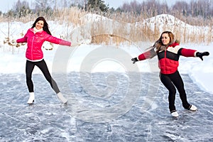 Coach of figure skating with apprentice practise at the frozen lake
