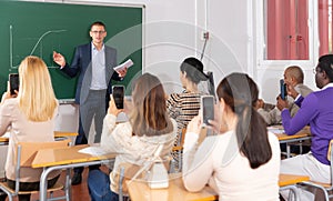 Coach giving presentation for adult audience in lecture hall