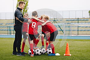 Coach Giving Young Soccer Team Instructions. Kids Sport Team Gathering. Children Play Sports