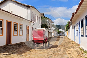 Coach on street, old colonial houses in Paraty, Brazil