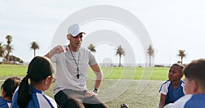 Coach, talking and children on field for soccer prepare for game, match and practice outdoors. Sports, teamwork and