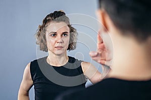 Coach teaches athlete to hit kick. Strong female martial arts athletes in their taekwon-do training. Two young women instructor