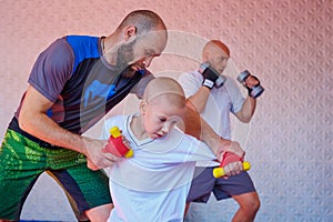 The coach teaches the boy kick Boxing