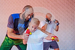 The coach teaches the boy kick Boxing