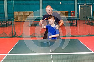 Coach teaches the Igart and table tennis. practice of the blow in table tennis