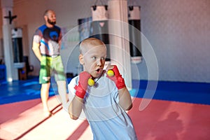 The coach trains the boxer shows strikes