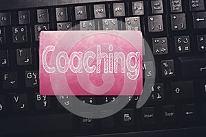 Coaching, message on the card above arabic keyboard