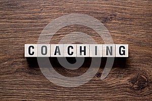 Coaching - word concept on building blocks, text