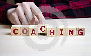 coaching word on a wooden blocks with hand