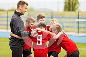 Coaching Youth Sports. Kids Soccer Football Team Huddle with Coach photo